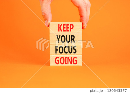 Keep your focus going symbol. Concept words Keep your focus going on beautiful wooden blocks. Beautiful orange table orange background. Business and keep your focus going concept. Copy space. 120643377