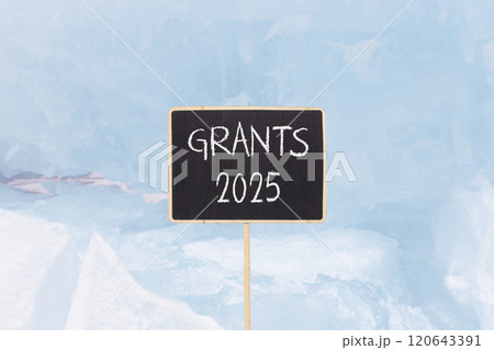 Planning grants 2025 new year symbol. Concept words Grants 2025 on beautiful yellow chalk blackboard. Beautiful Baikal lake blue ice background. Business grants 2025 new year concept. Copy space. 120643391