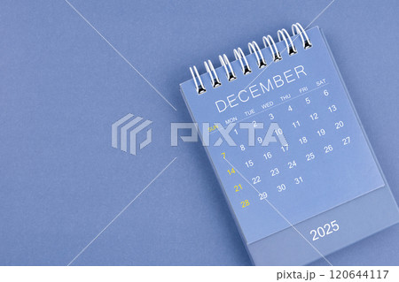 December 2025 calendar on blue background. Desk calendar for planning and organizing. 120644117