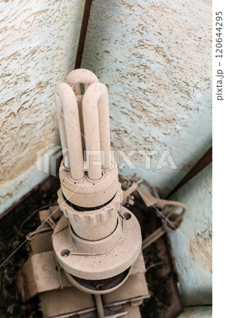 dirty halogen lamp inside outdoor light 120644295