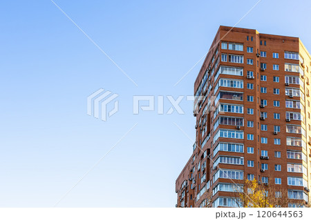 brick high-rise apartment building and blue sky 120644563