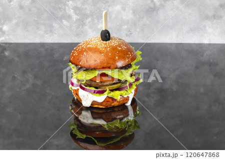 Grilled veggie burger with three cheese patty tomato cheese cucumber and lettuce Grilled veggie burger with three cheese patty tomato cheese cucumber and lettuce 120647868