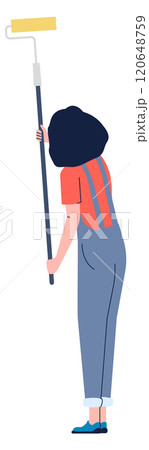 A woman in a red shirt and blue overalls is holding a paintbrush 120648759