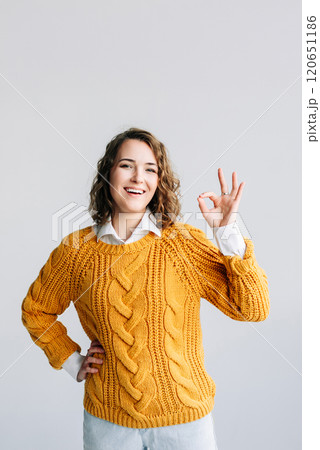 Confident Woman Gesturing OK. Smiling Lady Recommends Product with Hand Sign - Advertising Concept - 120651186