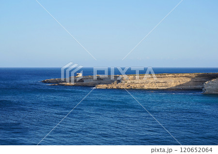Expansive coastal cliff stretching into calm blue Mediterranean sea, serene landscape under clear sunny sky Expansive coastal cliff stretching into calm blue Mediterranean sea, serene landscape under clear sunny sky 120652064