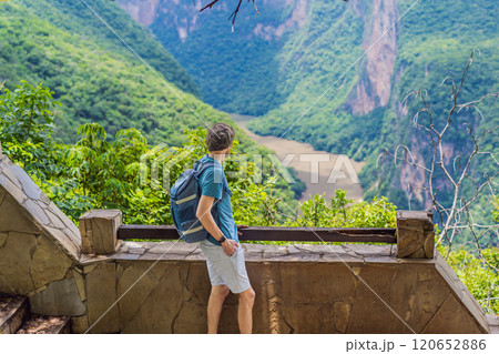 Male tourist exploring Sumidero Canyon National Park, Mexico. Adventure, natural exploration, and travel experience concept Male tourist exploring Sumidero Canyon National Park, Mexico. Adventure, natural exploration, and travel experience concept 120652886