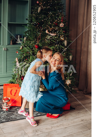 Little girl and her mom on Christmas morning at Little girl and her mom on Christmas morning at 120652905