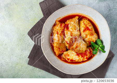 Stuffed cabbage rolls with minced meat, in tomato sauce, top view, without people, in the spotlight. Stuffed cabbage rolls with minced meat, in tomato sauce, top view, without people, in the spotlight. 120653036