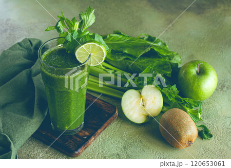 glass, with green smoothie, celery and spinach, apple and kiwi, cucumber, with ingredients on the table, vegetable smoothie, breakfast, homemade, no people, glass, with green smoothie, celery and spinach, apple and kiwi, cucumber, with ingredients on the table, vegetable smoothie, breakfast, homemade, no people, 120653061
