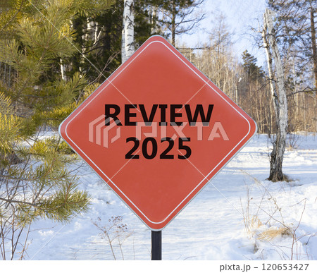 Planning review 2025 new year symbol. Concept words Review 2025 on beautiful red road sign. Beautiful winter forest background. Business review 2025 new year concept. Copy space. 120653427