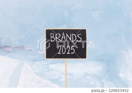 Planning brands 2025 new year symbol. Concept words Brands 2025 on beautiful yellow chalk blackboard. Beautiful blue Baikal lake ice background. Business brands 2025 new year concept. Copy space. Planning brands 2025 new year symbol. Concept words Brands 2025 on beautiful yellow chalk blackboard. Beautiful blue Baikal lake ice background. Business brands 2025 new year concept. Copy space. 120653452