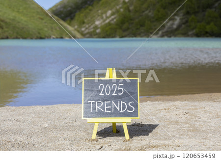 Planning 2025 trends new year symbol. Concept words 2025 Trends on beautiful yellow chalk blackboard. Beautiful mountain lake sand beach background. Business 2025 trends new year concept. Copy space. Planning 2025 trends new year symbol. Concept words 2025 Trends on beautiful yellow chalk blackboard. Beautiful mountain lake sand beach background. Business 2025 trends new year concept. Copy space. 120653459