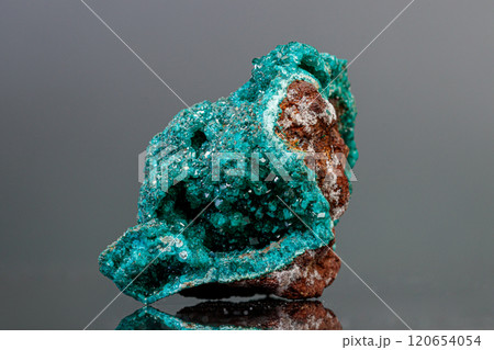 macro mineral stone Dioptase on a gray background 120654054