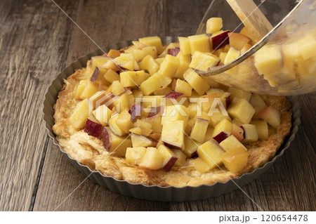 さつま芋とりんごのキッシュ　タルト　パイ　パイ生地にバターで炒めたさつまいもとりんごを入れる 120654478