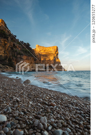 The rock rises above the blue sea 120655277