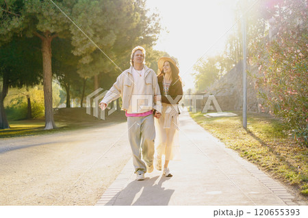 A Happy Couple Thriving and Enjoying a Beautiful Sunny Day Together Outdoors in Nature 120655393