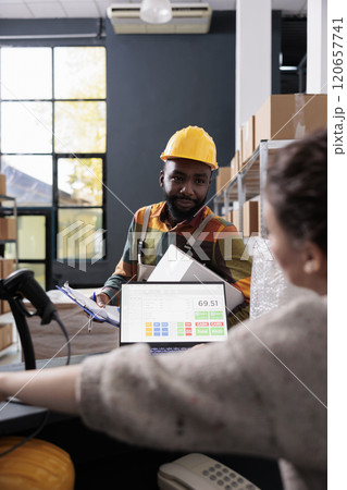 African american worker discussing products checklist with storehouse manager, preparing customers orders for delivery. Diverse stockroom employees working at goods inventory in warehouse African american worker discussing products checklist with storehouse manager, preparing customers orders for delivery. Diverse stockroom employees working at goods inventory in warehouse 120657741