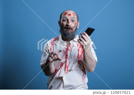 Portrait of mindless businessman worked to death taking telephone calls. Man working like zombie, using mobile phone, capitalism slave metaphor, isolated over studio background Portrait of mindless businessman worked to death taking telephone calls. Man working like zombie, using mobile phone, capitalism slave metaphor, isolated over studio background 120657821