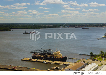 Ships, boats are docked at bustling port, reflecting activity on scene features variety of vessels scenic view of landscape 120658766
