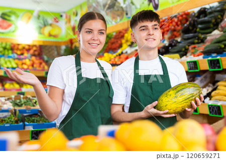 Portrait of friendly salespeople in fruit section of grocery store Portrait of friendly salespeople in fruit section of grocery store 120659271