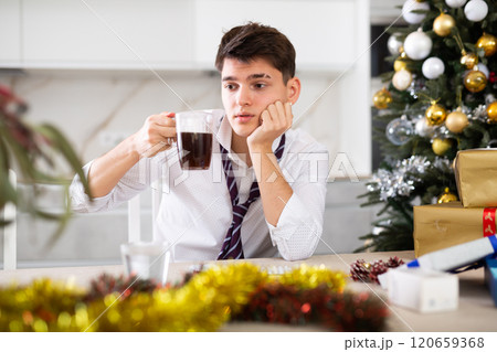 man suffering while hungover after new year party man suffering while hungover after new year party 120659368