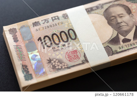 黒い背景に置かれた新一万円札の札束 黒い背景に置かれた新一万円札の札束 120661178