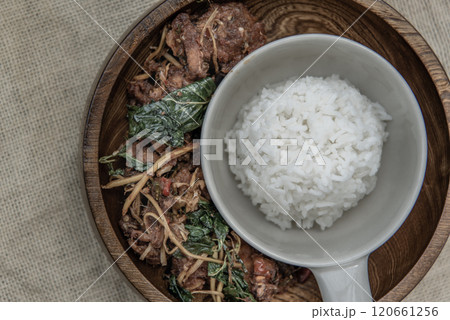 Thai Spicy food, Spicy Stir Fried Deep Fish Fillet with Herbs vegetables served with steamed rice in wooden bowl : in Thai language called "Pad Cha " 120661256