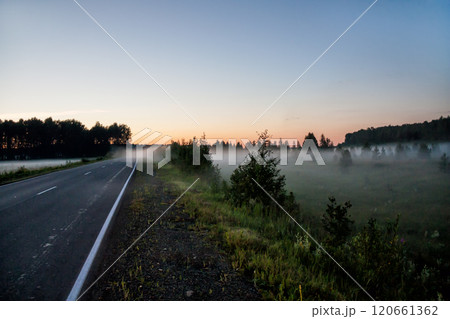 Ground fog near the road at sunset 120661362