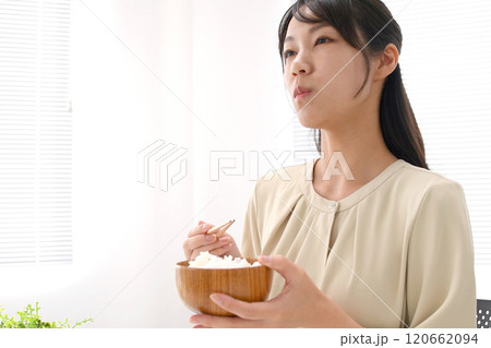 お茶碗と箸で白米を食べる若いアジア人女性 120662094