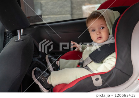 Caucasian toddler boy in car seat. Caucasian toddler boy in car seat. 120665415