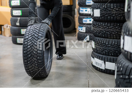 Mechanic keeps new studded car tires in garage.  Mechanic keeps new studded car tires in garage.  120665433