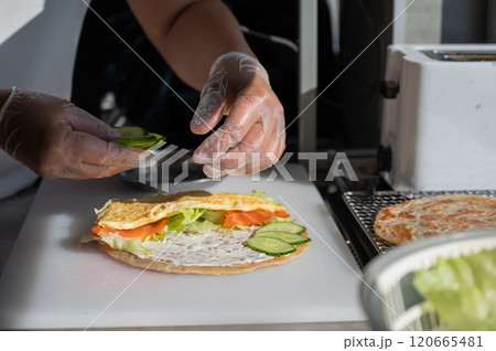 Chef prepares flatbread with salmon. Quesadilla.  120665481