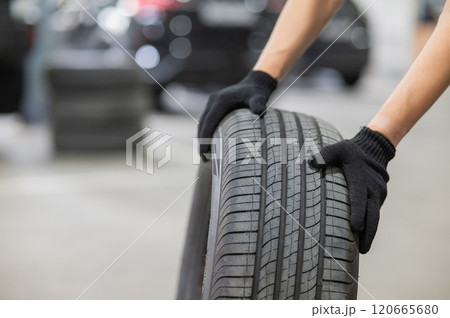 Man holding old car tire. Close up of mechanic's hands with wheel. Man holding old car tire. Close up of mechanic's hands with wheel. 120665680