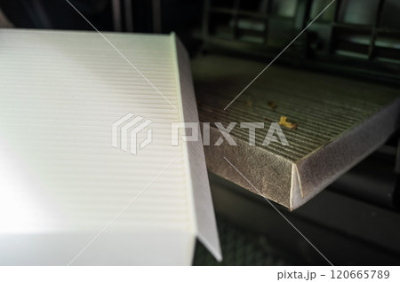 A mechanic changes the cabin air filter of a car. 120665789