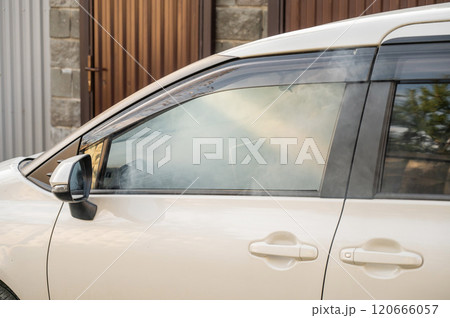 Smoke is coming from inside the car.  120666057