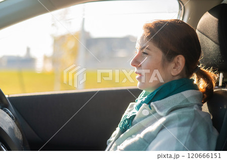 Portrait of a pensive Caucasian woman driving. Portrait of a pensive Caucasian woman driving. 120666151