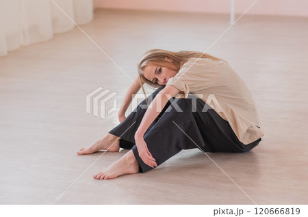 Caucasian woman dancing contemporary on the floor in a ballet class. Caucasian woman dancing contemporary on the floor in a ballet class. 120666819