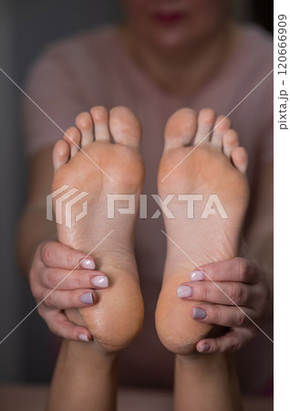 Close-up of a woman's feet massage. Vertical photo. 120666909