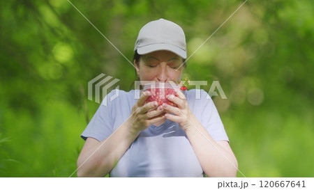Young Woman Offers Jar With Wild Strawberries. Female Hands With Strawberries. Woman Holds To Bank With Juicy Red Wild Strawberry. Close Up. Young Woman Offers Jar With Wild Strawberries. Female Hands With Strawberries. Woman Holds To Bank With Juicy Red Wild Strawberry. Close Up. 120667641