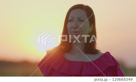 Girl Blowing On A Dandelion. Portrait Of Beauty Young Brunette Woman At Summer Sunset Time. Concept Of Happy Carefree Lifestyle. Steadicam Shot. Girl Blowing On A Dandelion. Portrait Of Beauty Young Brunette Woman At Summer Sunset Time. Concept Of Happy Carefree Lifestyle. Steadicam Shot. 120668349