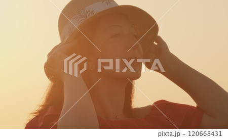 Free Woman Relax In Beautiful Sunset. Beautiful Young Woman Wearing Dress And Hat In Nature. Beauty Smiling Face. Close Up. Free Woman Relax In Beautiful Sunset. Beautiful Young Woman Wearing Dress And Hat In Nature. Beauty Smiling Face. Close Up. 120668431