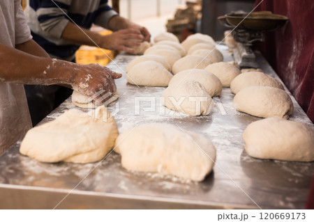 Male hands knead yeast dough for baking bread 120669173