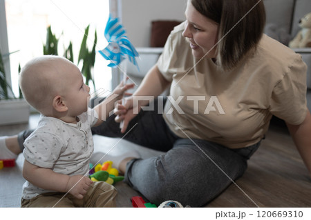 Engaging Playtime Filled with Joy and Love Between a Caring Mother and Her Beloved Baby Engaging Playtime Filled with Joy and Love Between a Caring Mother and Her Beloved Baby 120669310