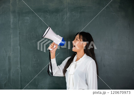 A woman is holding a microphone and making a loud noise. She is smiling and she is happy. Back to School A woman is holding a microphone and making a loud noise. She is smiling and she is happy. Back to School 120670973