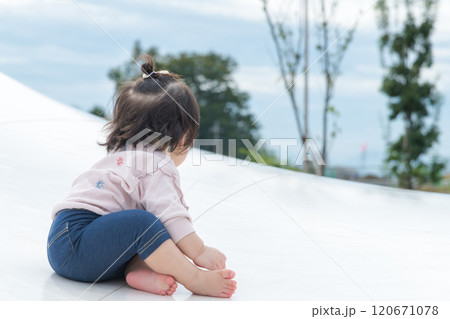 【巨大な遊具でお座りする乳幼児】 【巨大な遊具でお座りする乳幼児】 120671078