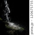 Waterfall. Close-up of the cold water flow of a waterfall with contrasting shadows on a sunny day. 120675735