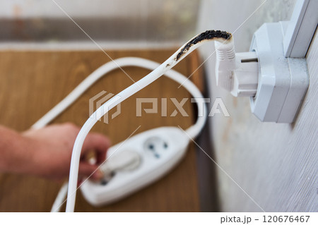 Power strip extension cord overload with burn marks on it. 120676467