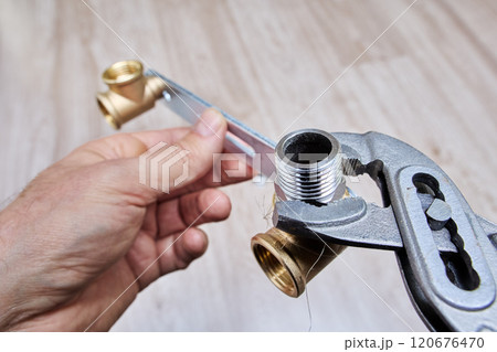 Brace bracket for mixer tap, plumber installs plug using an adjustable wrench. 120676470