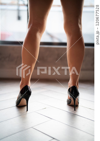 Woman feet high heels shoes in bathrobe at home, closeup 120677528