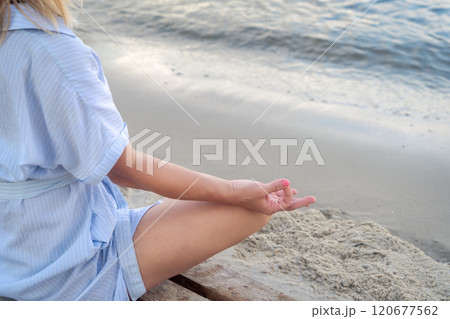 Woman meditating at the sea Woman meditating at the sea 120677562